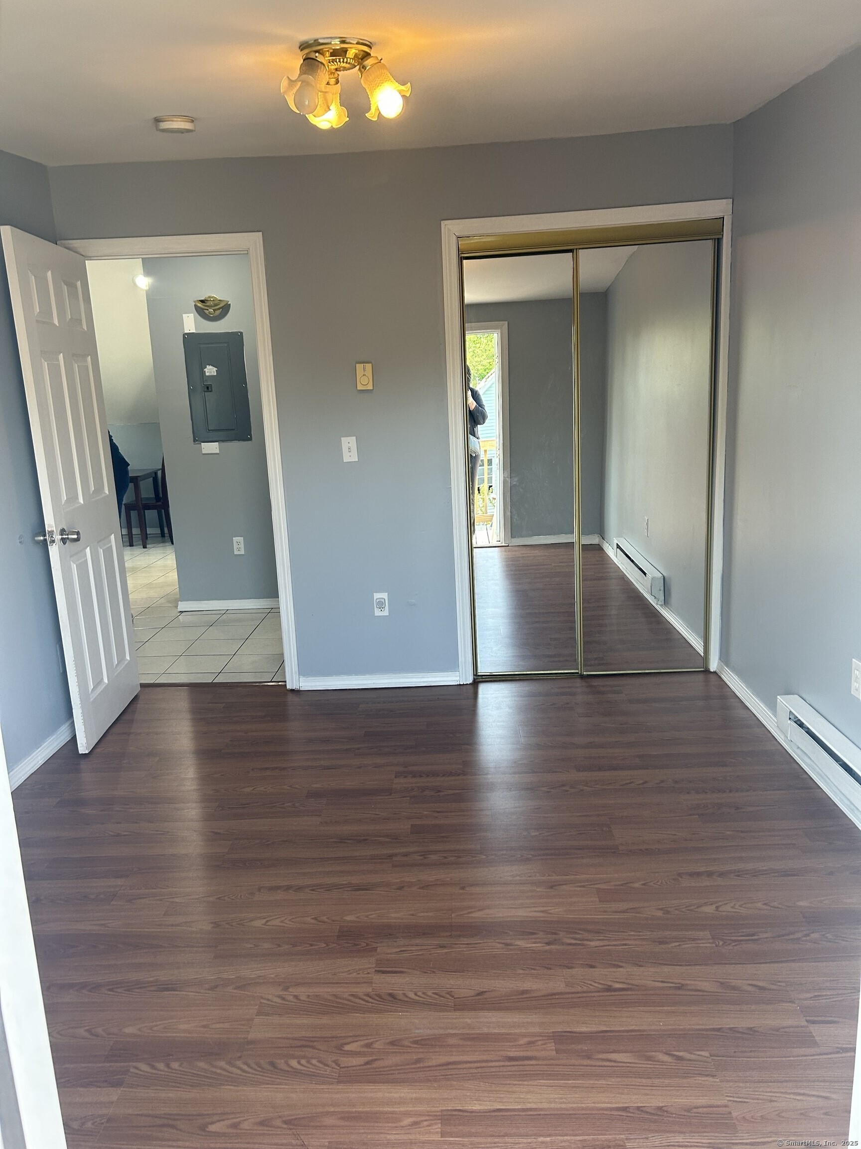 280 Bassett Street New Haven, CT 06511 - Photo 3 of 9 a view of a livingroom with wooden floor and a large mirror