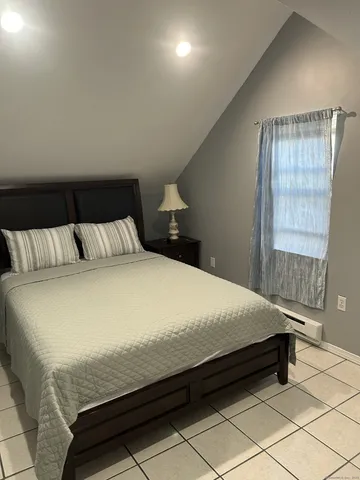 a bedroom with a bed and a window