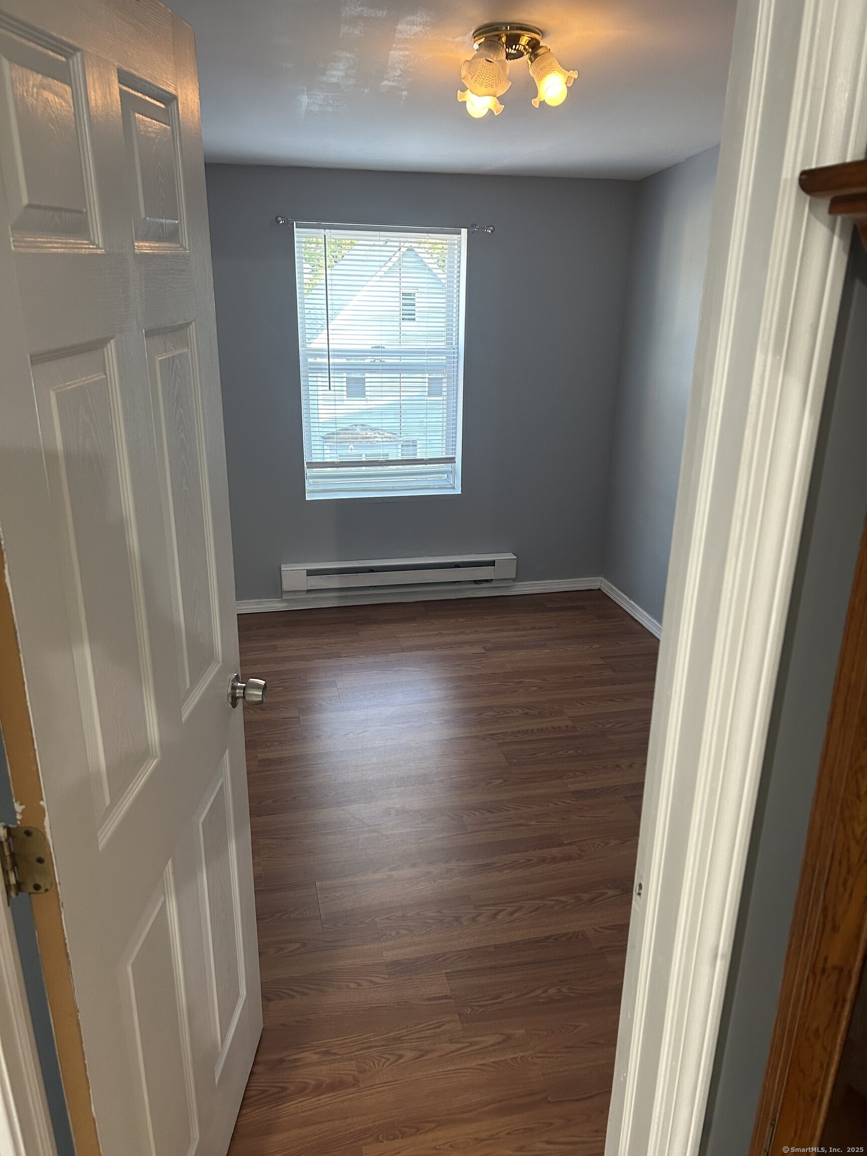 280 Bassett Street New Haven, CT 06511 - Photo 5 of 9 a view of an empty room with wooden floor and a window