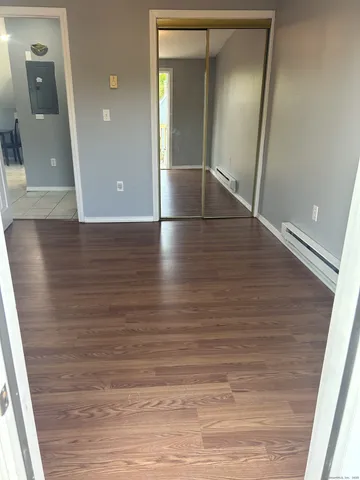 wooden floor in an empty room with a mirror