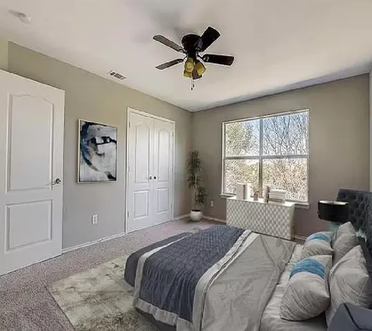 a bedroom with a bed and window