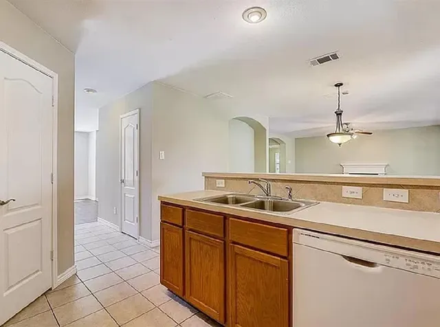 a kitchen with a sink and a refrigerator