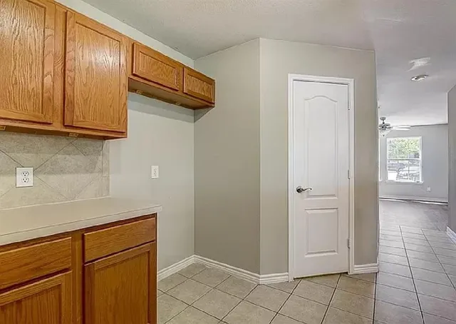 a view of a kitchen with white cabinets
