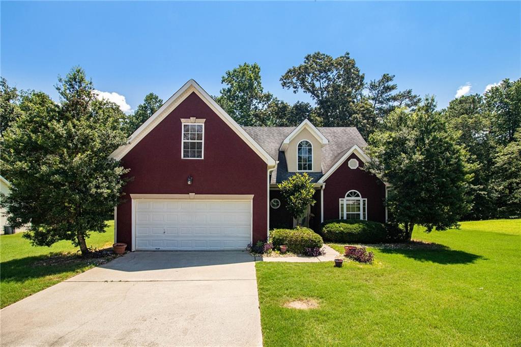 a front view of a house with yard