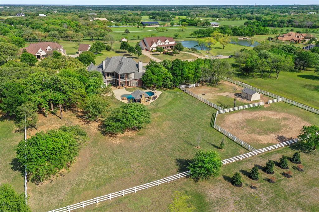 an aerial view of residential houses with outdoor space and street view