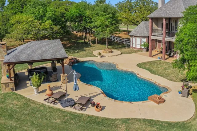a view of a house with backyard porch and sitting area