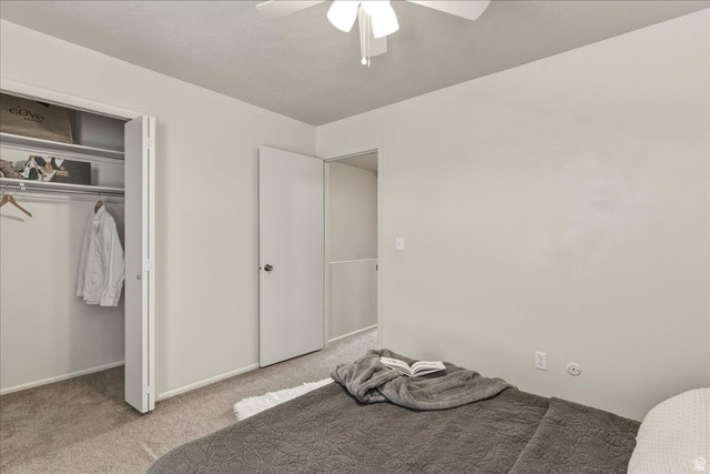 947 Canyon Road, Unit 29 Ogden, UT 84404 - Photo 11 of 19 Unfurnished bedroom with carpet floors, ceiling fan, and a closet