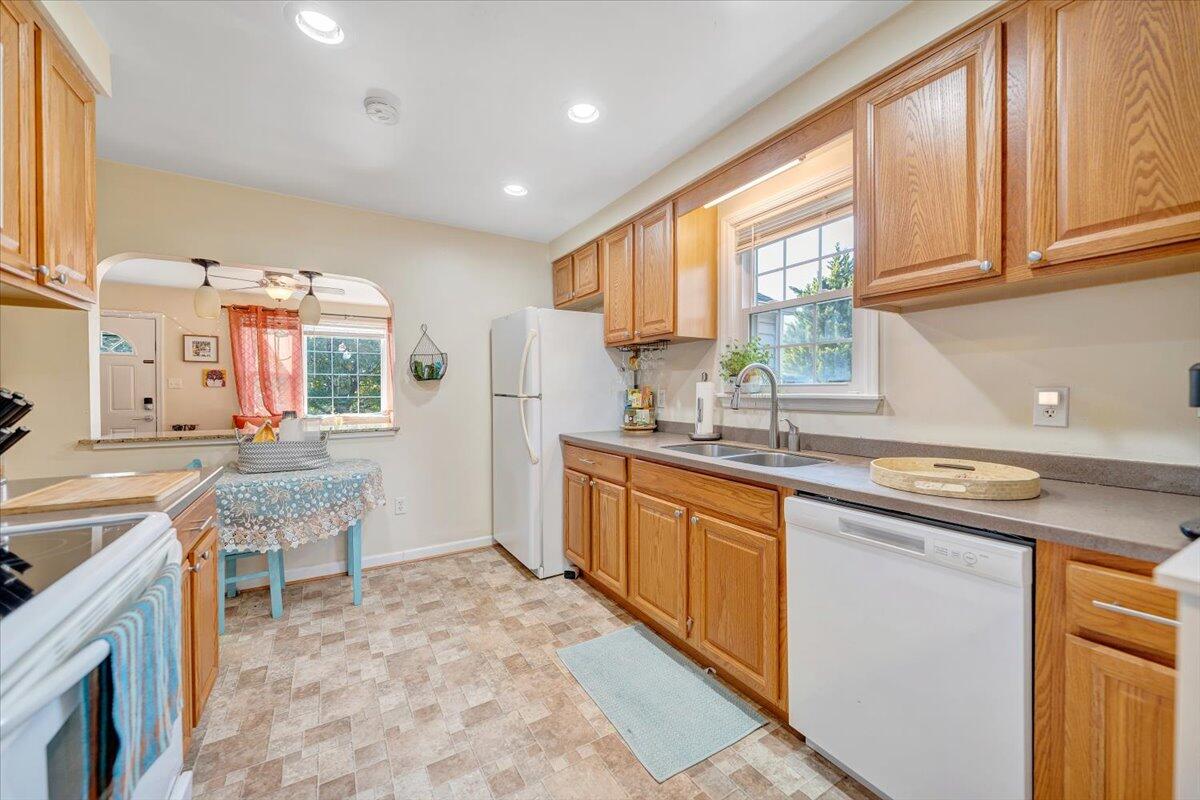 4915 Hildebrand Road Northwest Roanoke, VA 24012 - Photo 12 of 40 a kitchen with stainless steel appliances granite countertop a stove a sink and a refrigerator