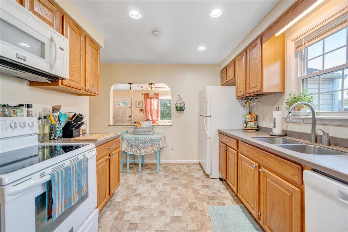4915 Hildebrand Road Northwest Roanoke, VA 24012 - Photo 13 of 40 a kitchen with stainless steel appliances granite countertop a stove a sink dishwasher and cabinets with wooden floor