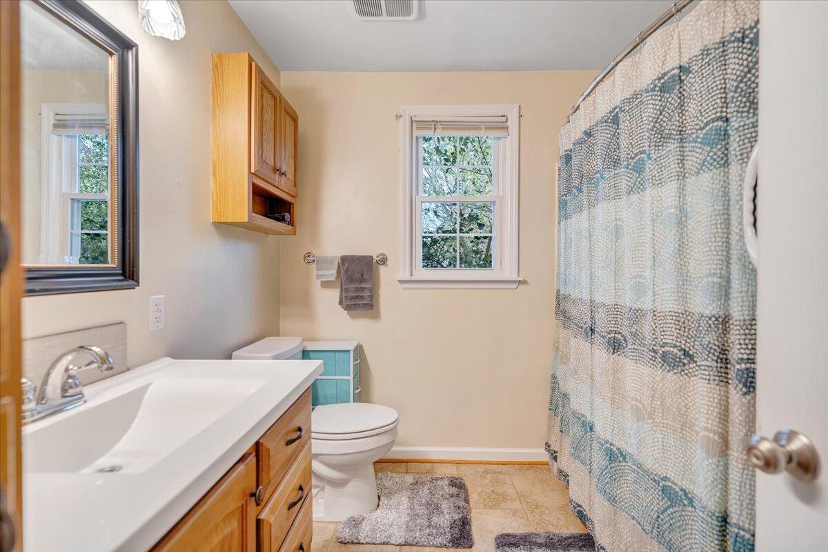 4915 Hildebrand Road Northwest Roanoke, VA 24012 - Photo 23 of 40 a bathroom with a sink toilet and shower