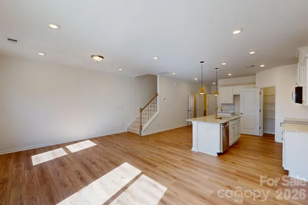 a view of kitchen with cabinets and wooden floor