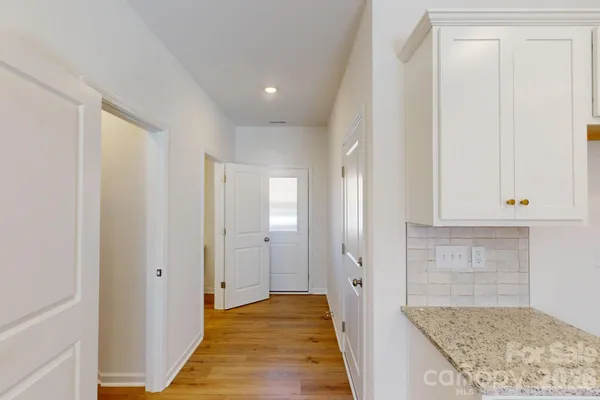 a view of hallway with kitchen