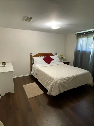 a bedroom with a bed and window