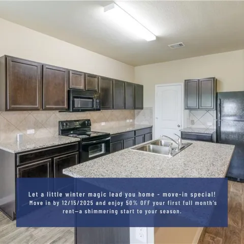 a kitchen with stainless steel appliances granite countertop a stove a sink a microwave a refrigerator and cabinets