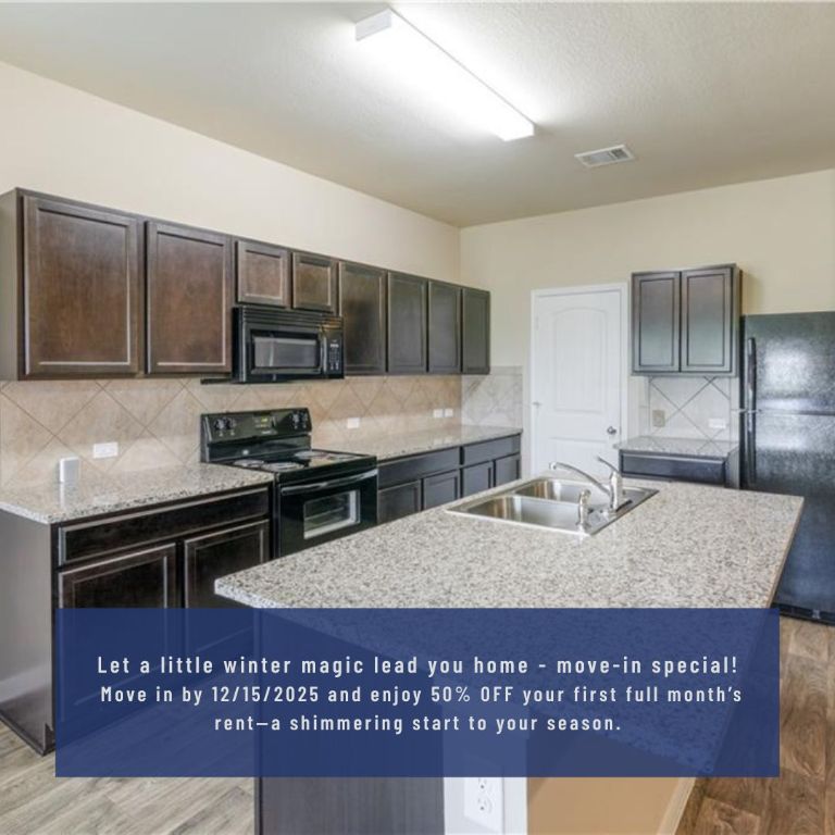 a kitchen with stainless steel appliances granite countertop a stove a sink a microwave a refrigerator and cabinets