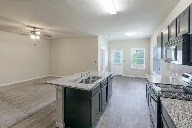 a kitchen with a stove a sink and a refrigerator