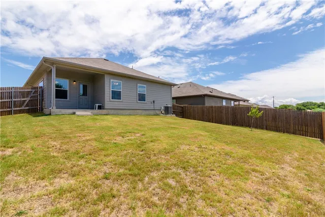 a blue swimming pool with a yard