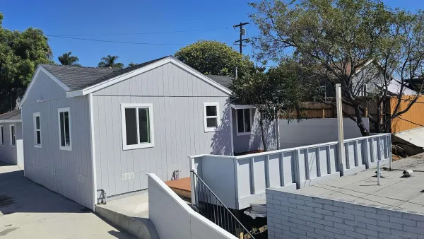 a view of a house with backyard and deck