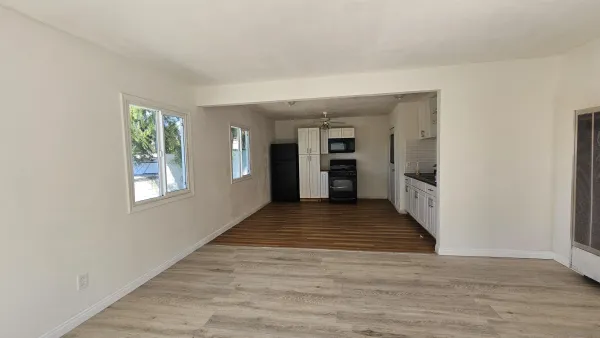 a view of a room with furniture and wooden floor