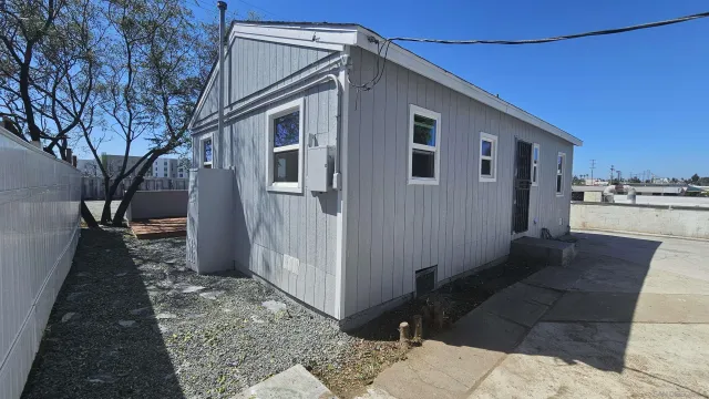 a front view of a house with a garden