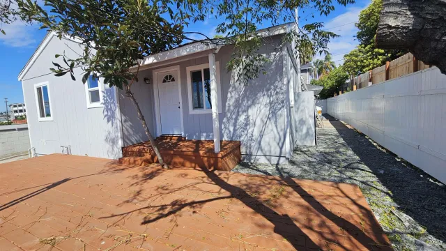 a bedroom with a bed and a potted plant