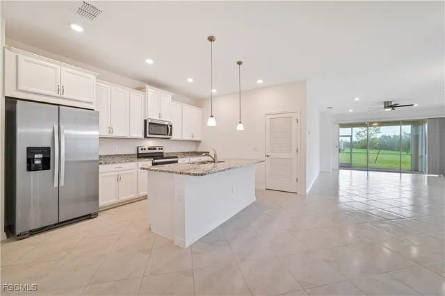 a kitchen with a refrigerator and a stove
