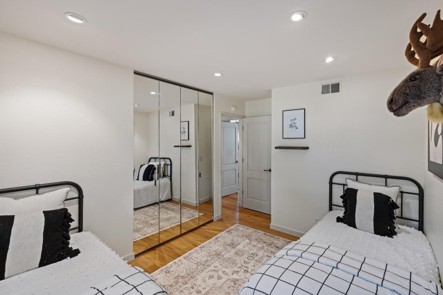 26571 Aspen Place Carmel, CA 93923 - Photo 29 of 46 a bedroom with a bed a rug with the bathroom