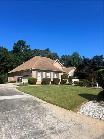 a view of a big house with a big yard