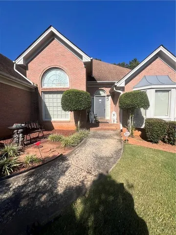a front view of a house with garden