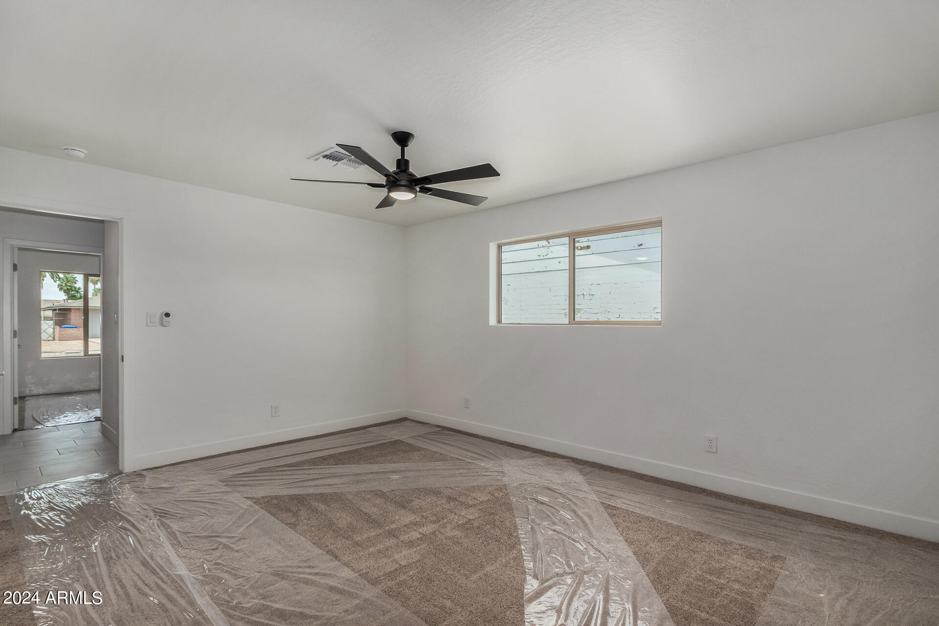 4109 West Hatcher Road Phoenix, AZ 85051 - Photo 17 of 33 a view of a big room with wooden floor and windows