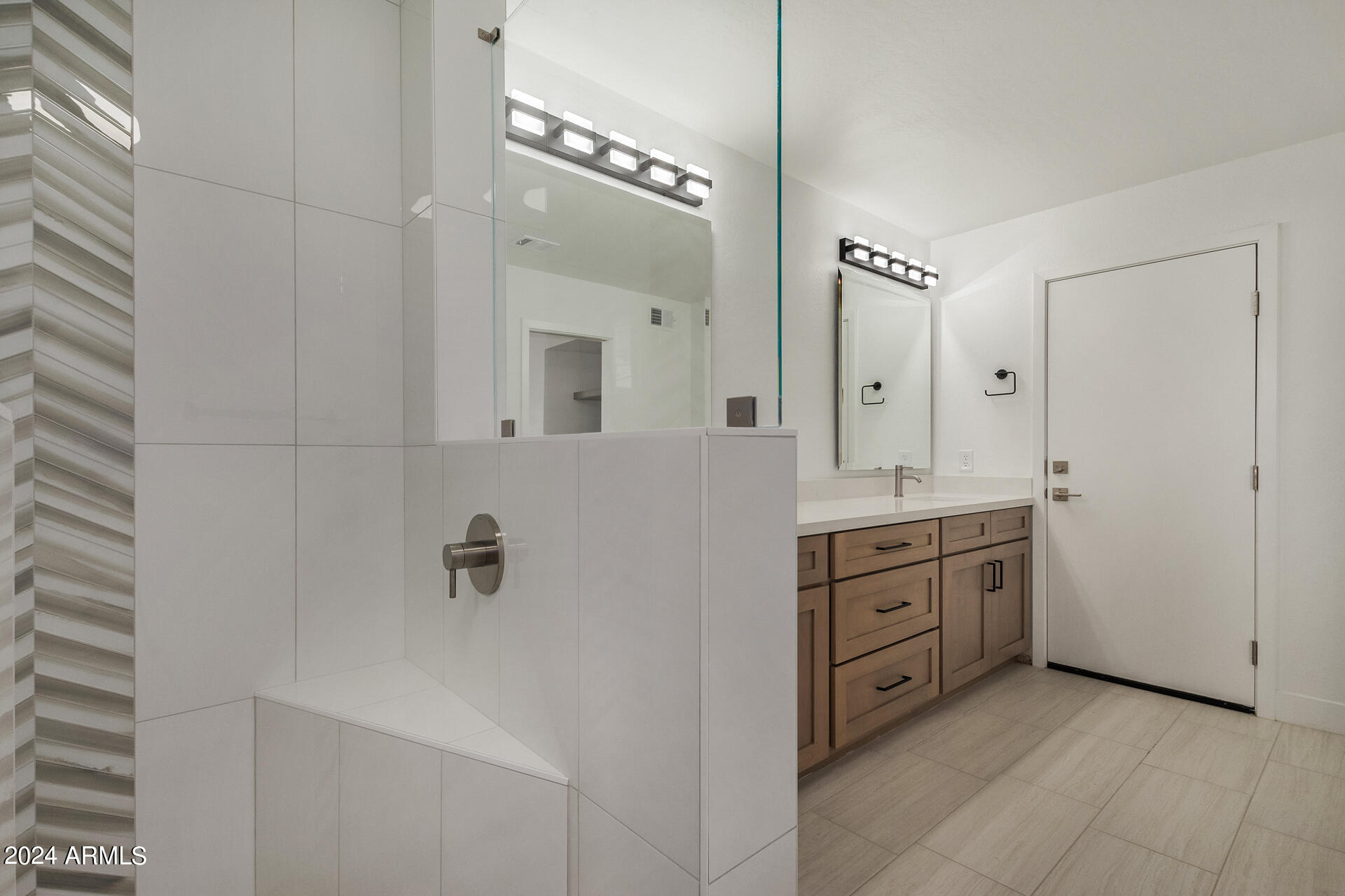 4109 West Hatcher Road Phoenix, AZ 85051 - Photo 20 of 33 a bathroom with a granite countertop sink a mirror and a bathtub