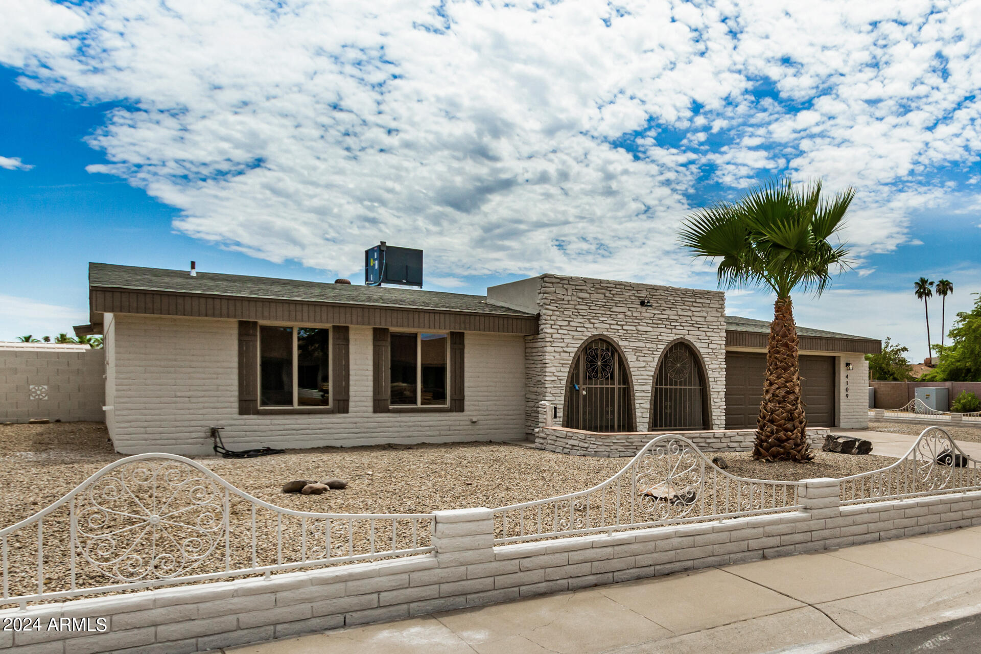 4109 West Hatcher Road Phoenix, AZ 85051 - Photo 5 of 33 a front view of a house with a yard and garage