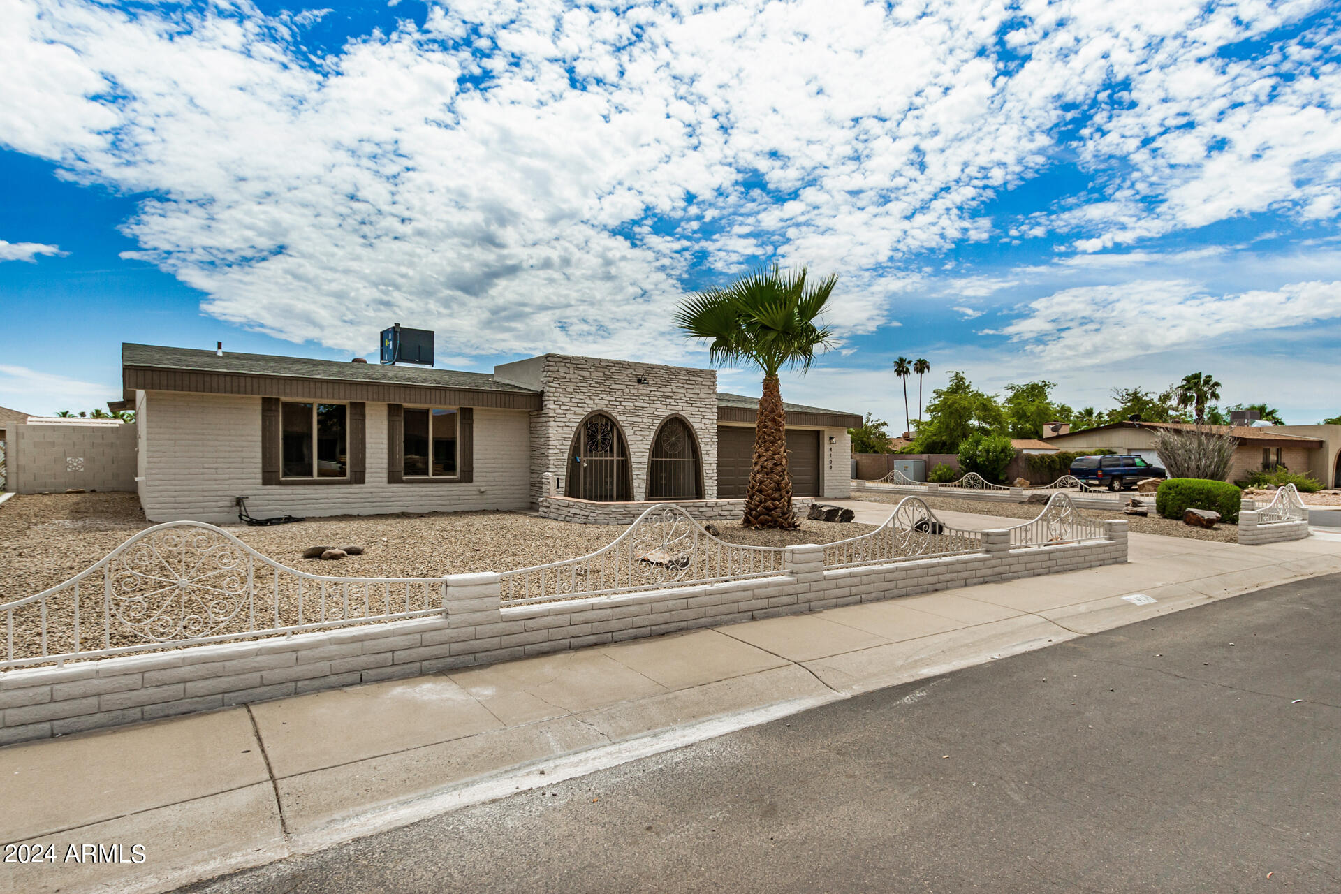 4109 West Hatcher Road Phoenix, AZ 85051 - Photo 6 of 33 a view of a house with a cars park side of road