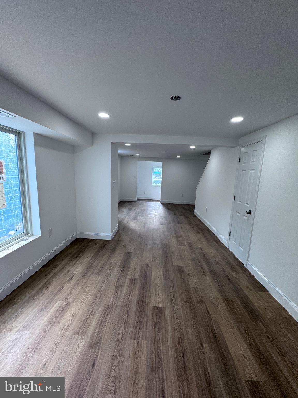 4667 Hawthorne Street Philadelphia, PA 19124 - Photo 4 of 21 an empty room with wooden floor and windows