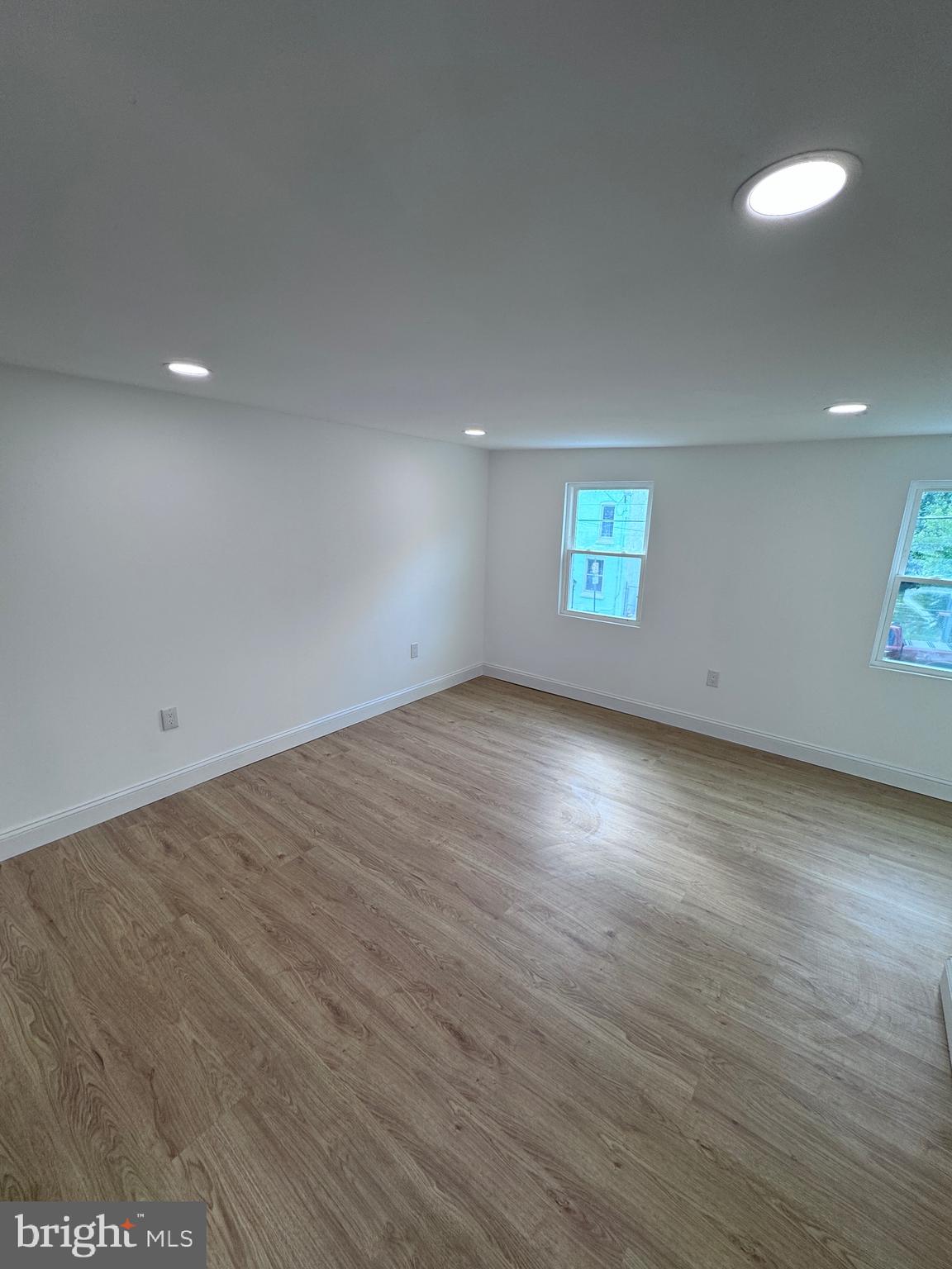 4667 Hawthorne Street Philadelphia, PA 19124 - Photo 5 of 21 an empty room with wooden floor and windows