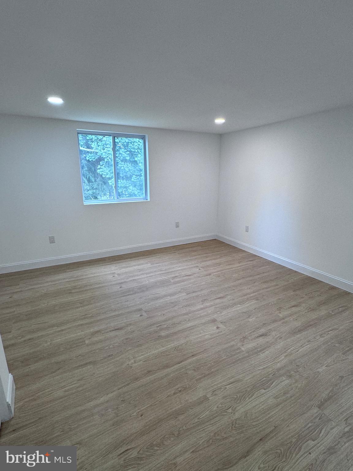 4667 Hawthorne Street Philadelphia, PA 19124 - Photo 10 of 21 an empty room with wooden floor and windows