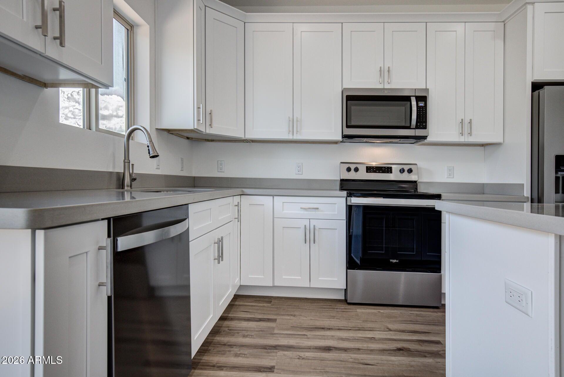 2002 East Thunder Mountain Payson, AZ 85541 - Photo 11 of 34 a kitchen with white cabinets stainless steel appliances and sink