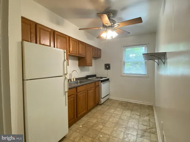 a kitchen with stainless steel appliances granite countertop a refrigerator a stove a sink and dishwasher