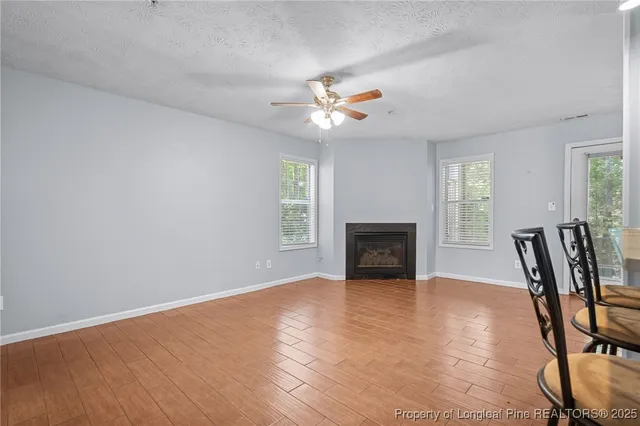 a living room with a fireplace and windows