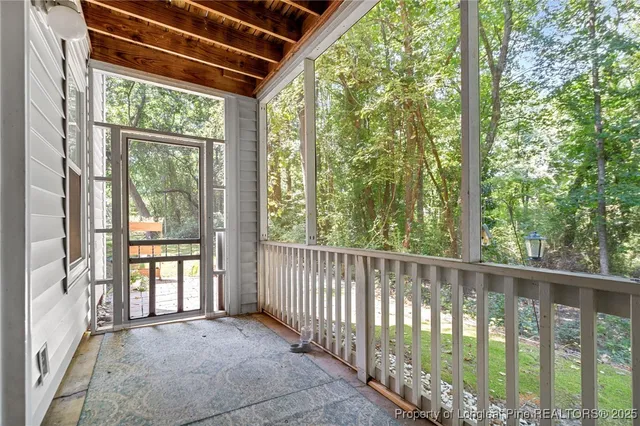 a view of a chair and table in back yard of the house