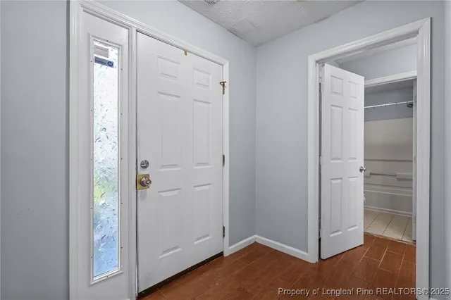 a view of a hallway with wooden floor