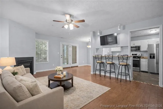 a view of a livingroom with furniture flat screen tv and wooden floor