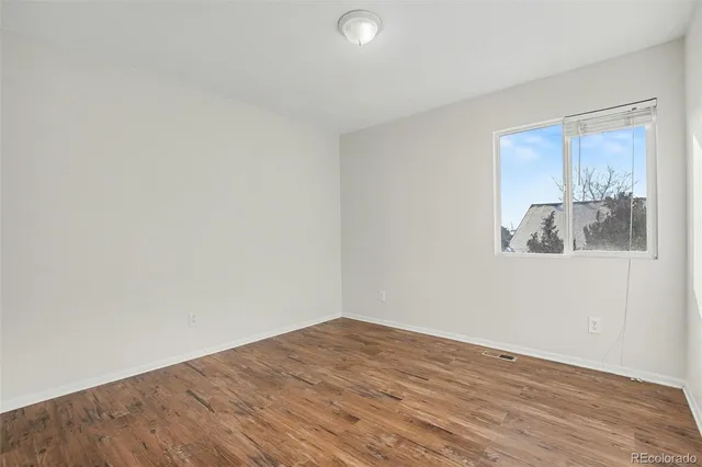 a view of a room with wooden floor and cabinet