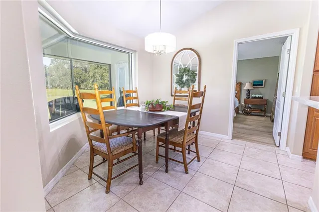 a view of a dining room with furniture and a window
