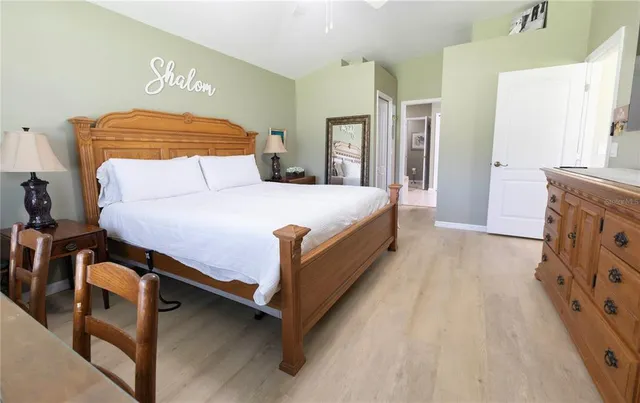 a bedroom with a bed and a table in it