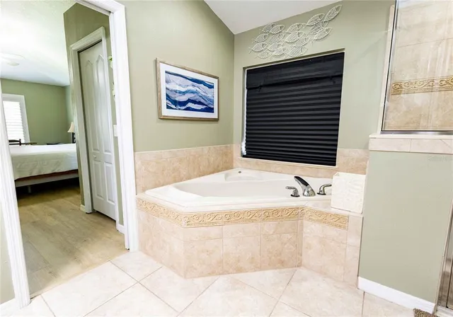 a bedroom with two beds and a chair