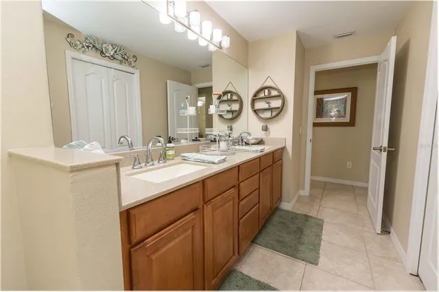 a spacious bathroom with a double vanity sink mirror and
