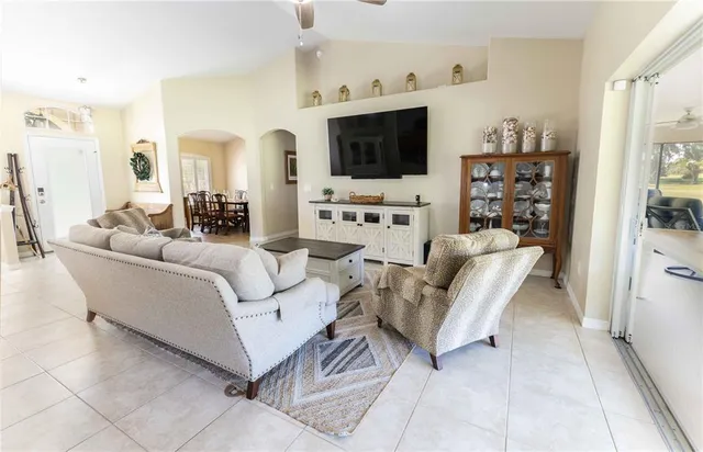 a living room with furniture a table and a chandelier