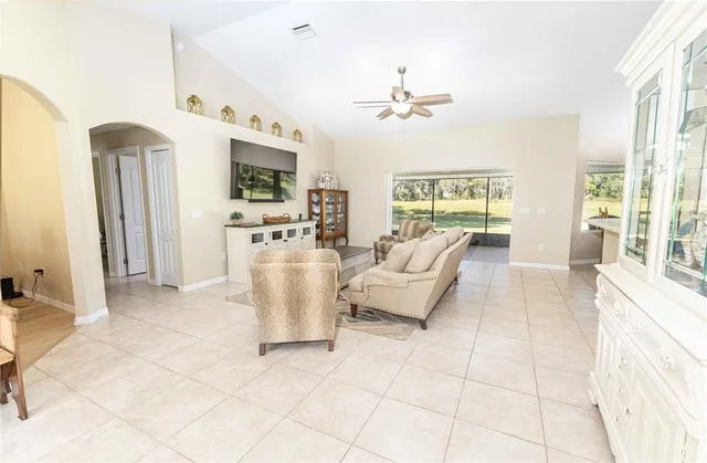 a living room with furniture a table and a chandelier