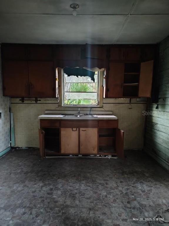823 South Warner Avenue Perry, FL 32348 - Photo 21 of 30 a kitchen with granite countertop a stove a sink and a microwave
